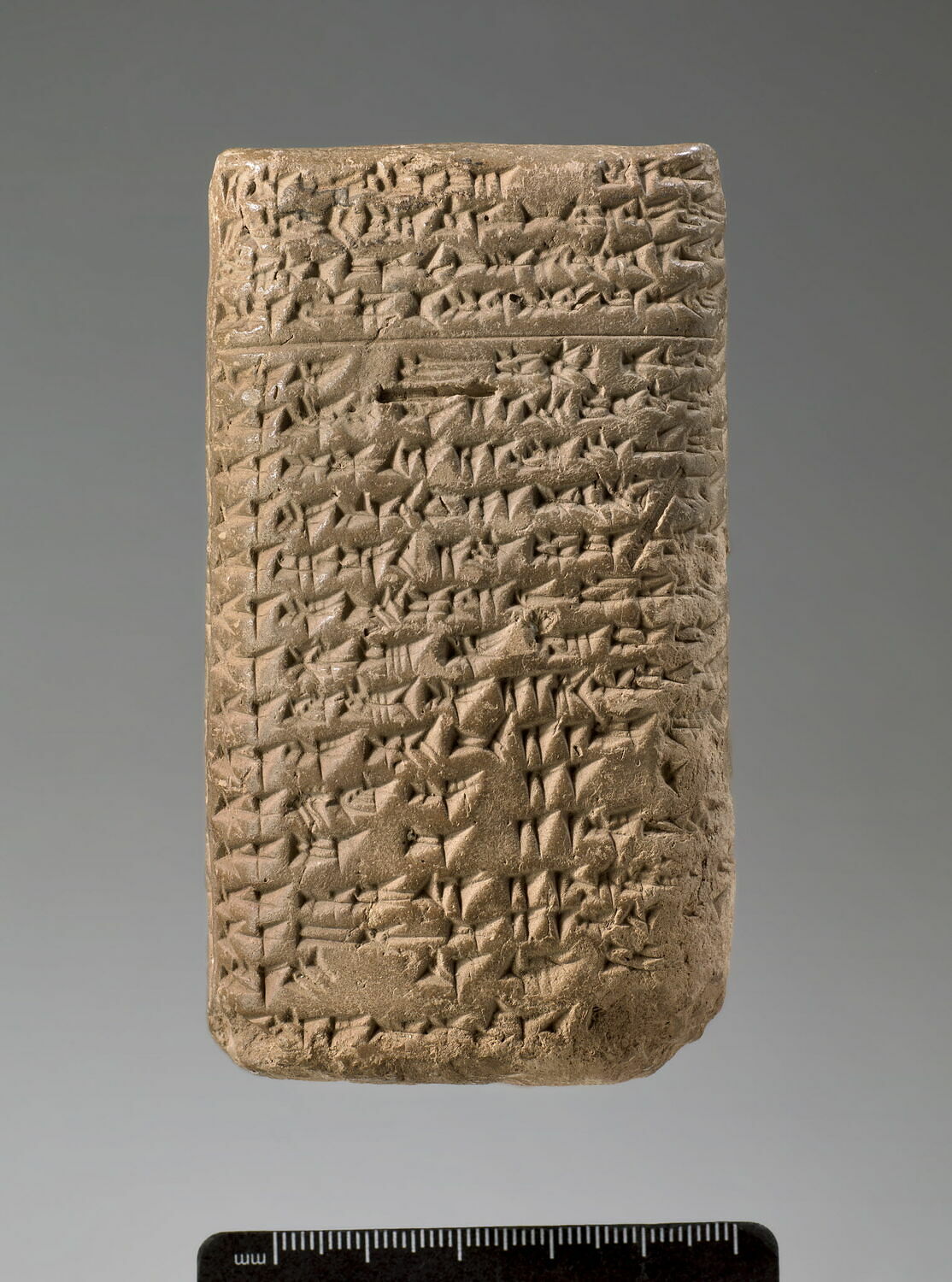 Clay tablet covered in cuneiform writing