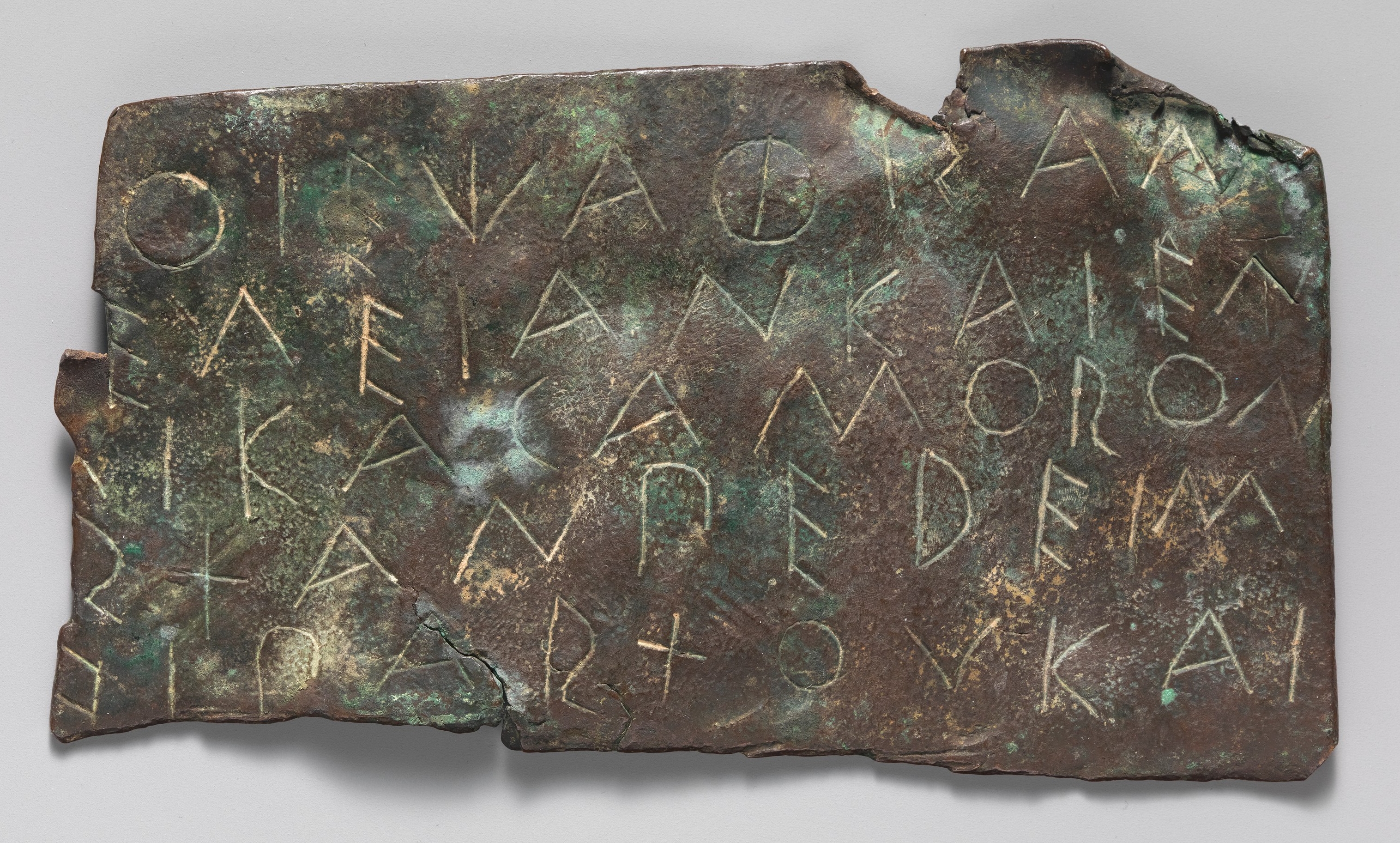 Bronze fragment with carved Archaic Greek text